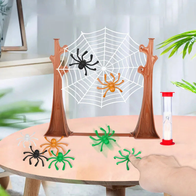 Spider board game on a table with green, orange, and black spiders and a sand timer