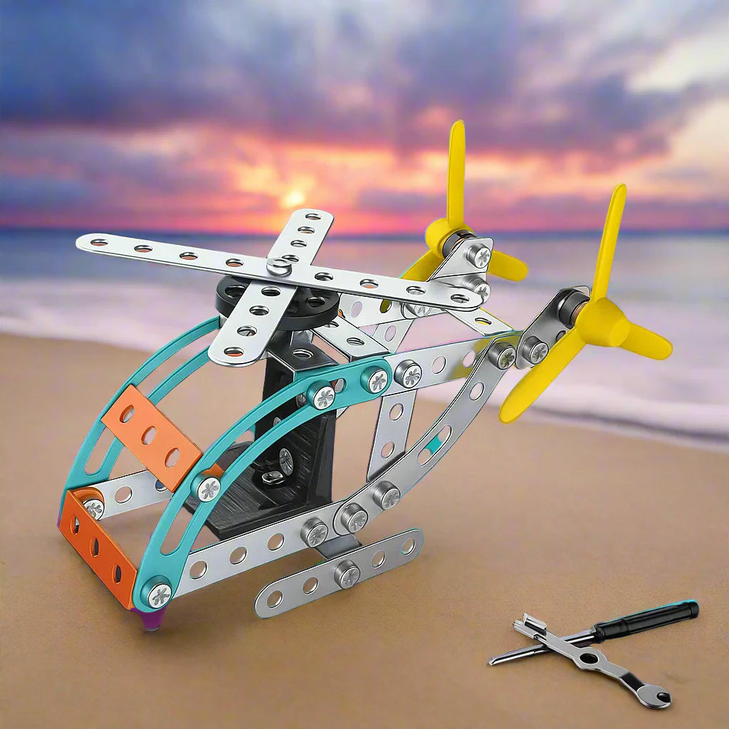 Metal helicopter model with a teal cockpit frame, silver main rotor, and landing skids