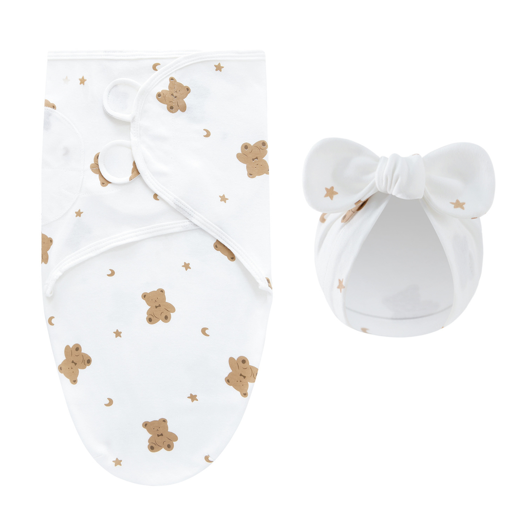 White swaddle blanket and matching bow hat with brown teddy bears and small stars
