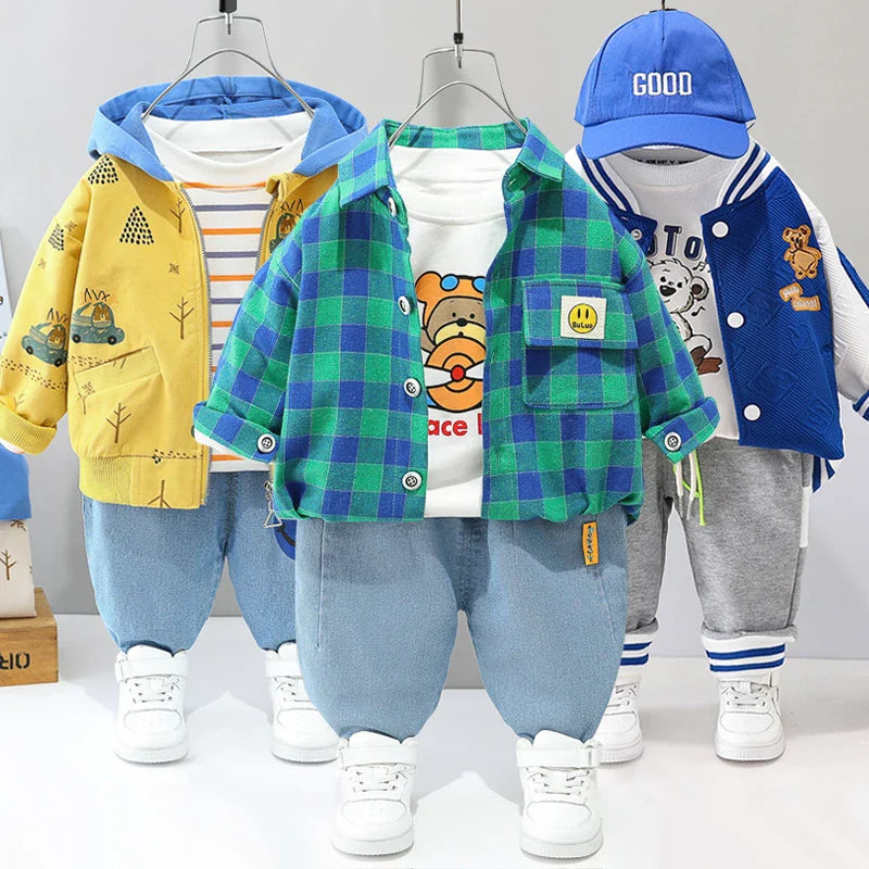 Yellow hooded, green-and-blue checkered, and blue varsity clothing sets displayed together