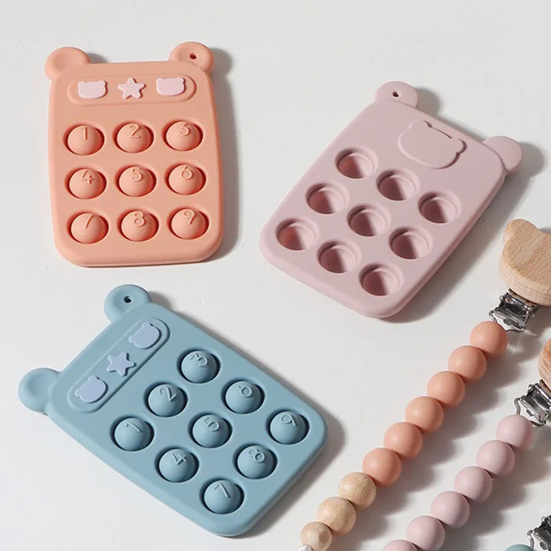 Orange, pink, and blue silicone phones arranged beside beaded clip straps