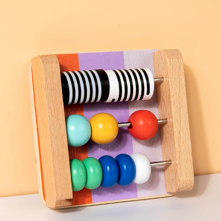 Wooden counting-bead board with colorful beads and black-and-white discs on three rows.