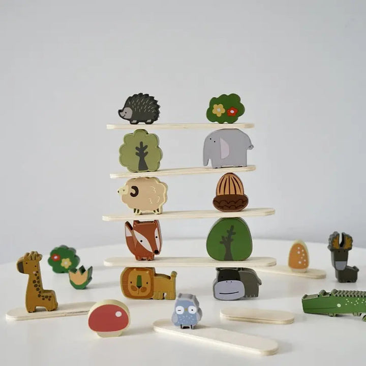 Wooden animal tower with elephant, sheep, fox, and tree blocks on balancing sticks.