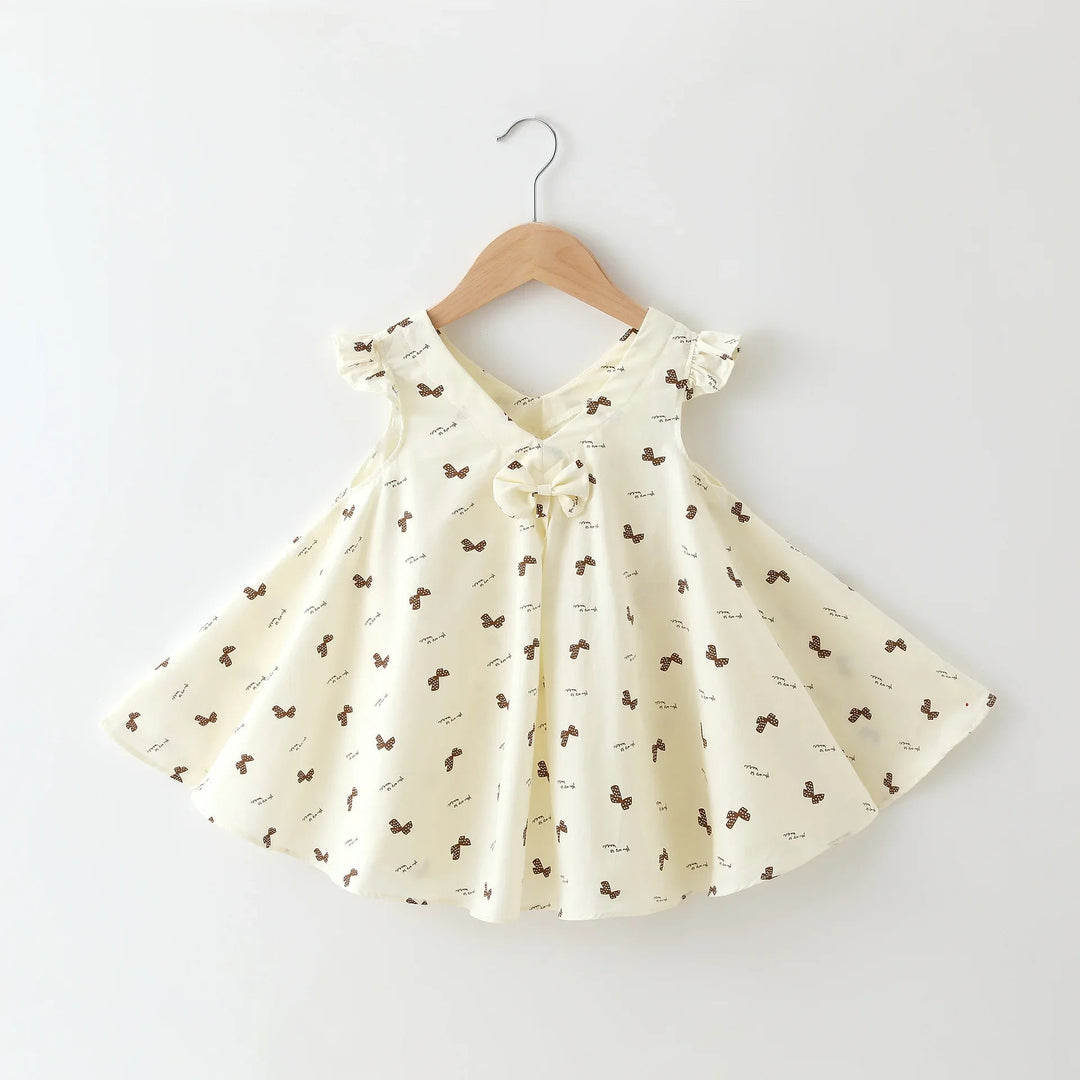 Cream girls' dress with tiny bow print, flutter sleeves, a V-neck, and front bow