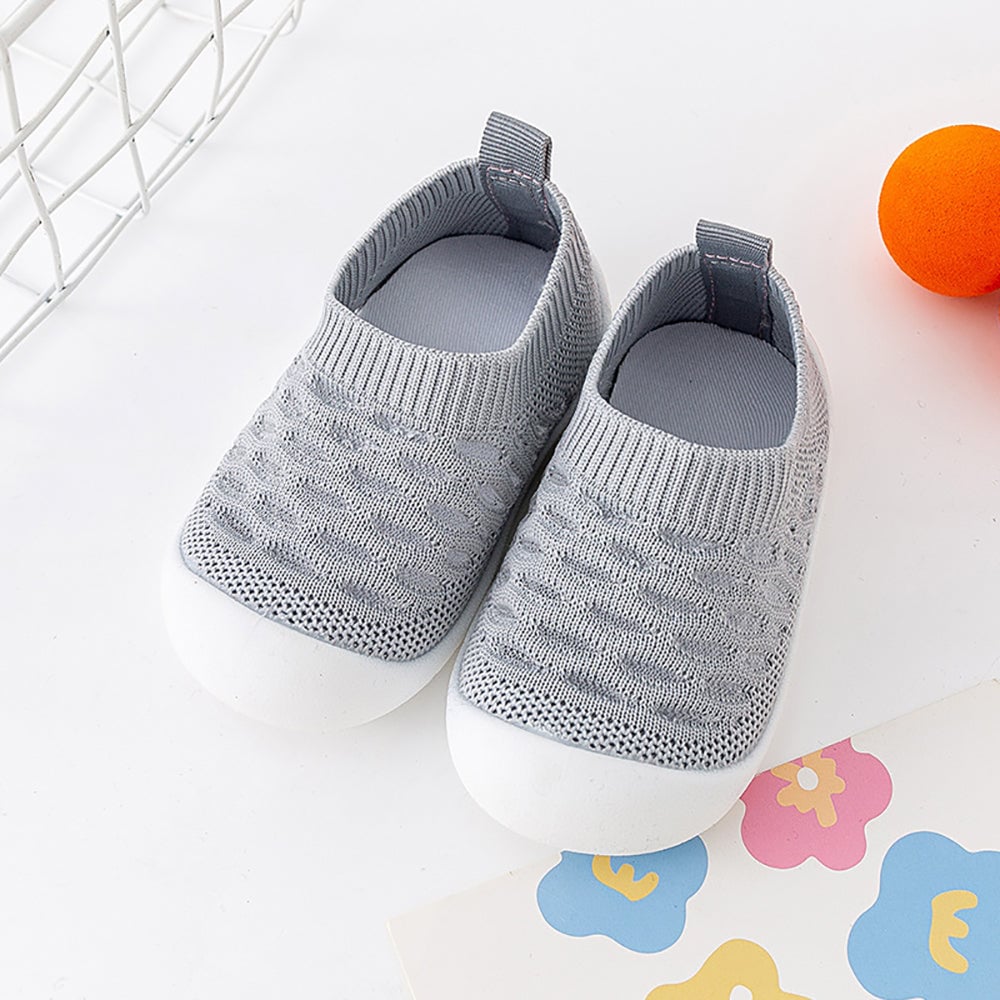 Pair of gray knit slip-on shoes with heel pull tabs and white soles