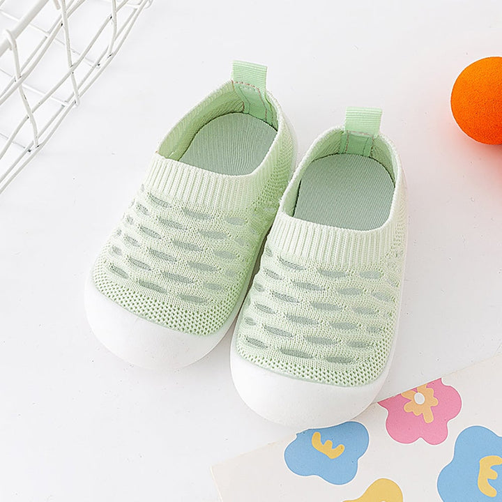Pair of pale green knit slip-on shoes with white soles