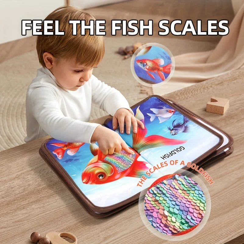 Child touching a colorful fish page with a shiny, scale-textured panel.