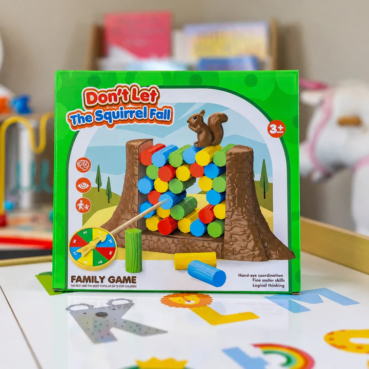 Green game box showing a squirrel balancing on colorful tokens, marked ages 3 and up