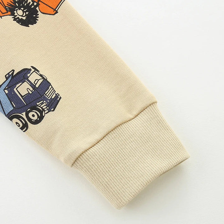 Long sweatshirt sleeve with a blue truck print and beige ribbed cuff