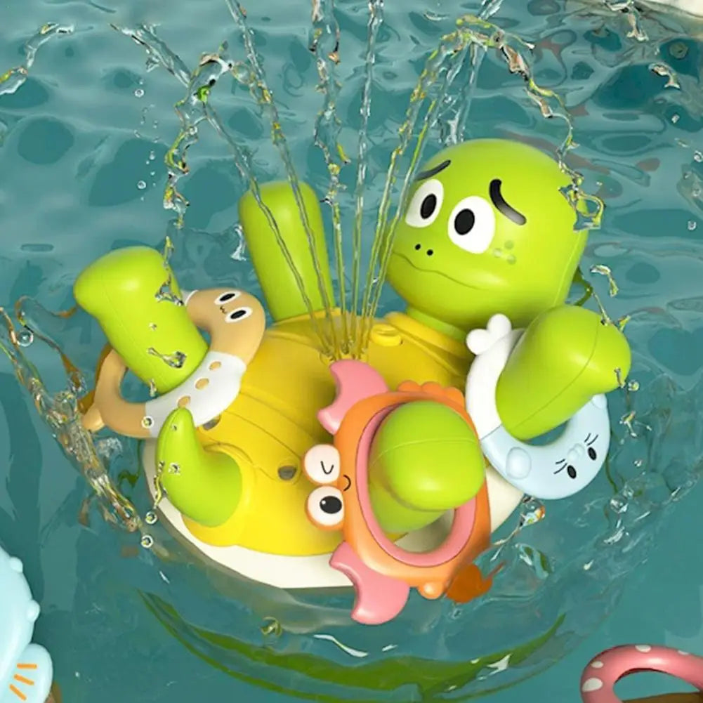 Green and yellow turtle bath toy spraying water with colorful animal-shaped rings around its raised limbs.