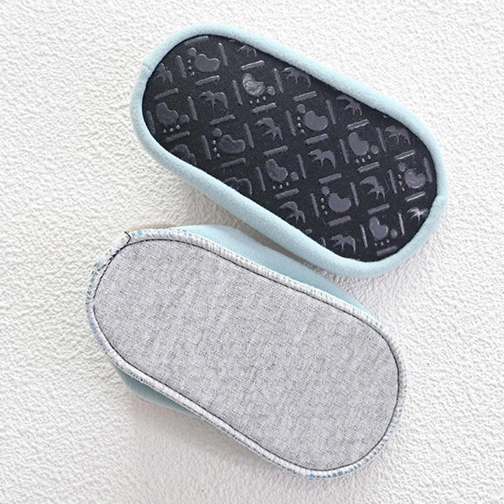 Textured black water-shoe outsole beside a gray footbed