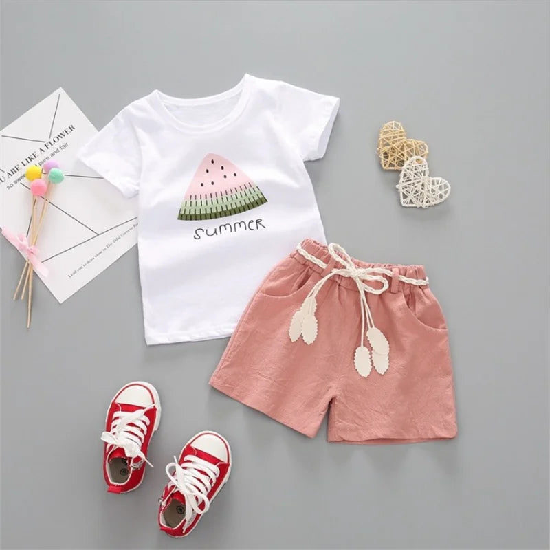 White watermelon T-shirt beside pink shorts with a gathered waistband