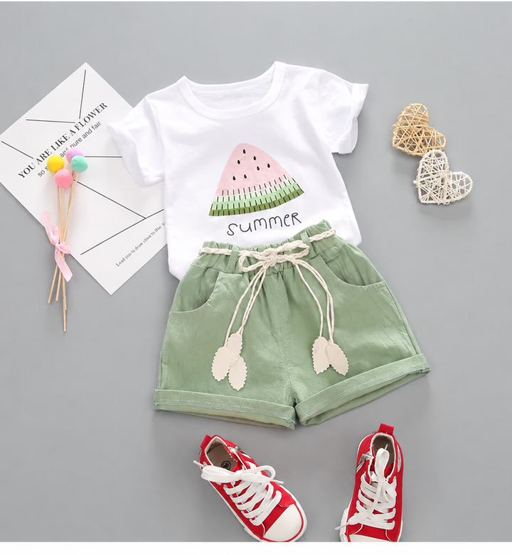 White watermelon-print T-shirt with green shorts and leaf-shaped tie details