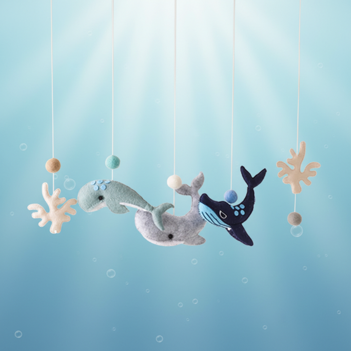Whale-themed hanging toys with whale figures, coral shapes, and beads.