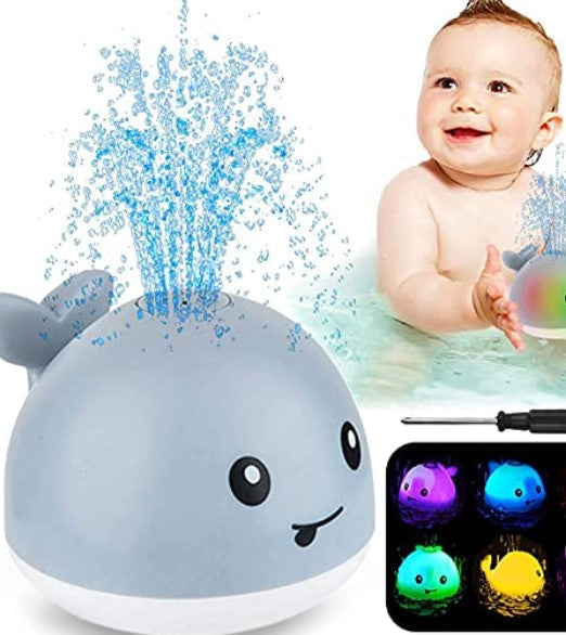 Gray whale bath toy spraying water, with a child and examples of its colorful LED lights.