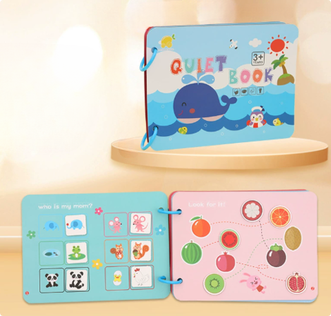 Whale-cover quiet book displayed above open animal and fruit matching pages