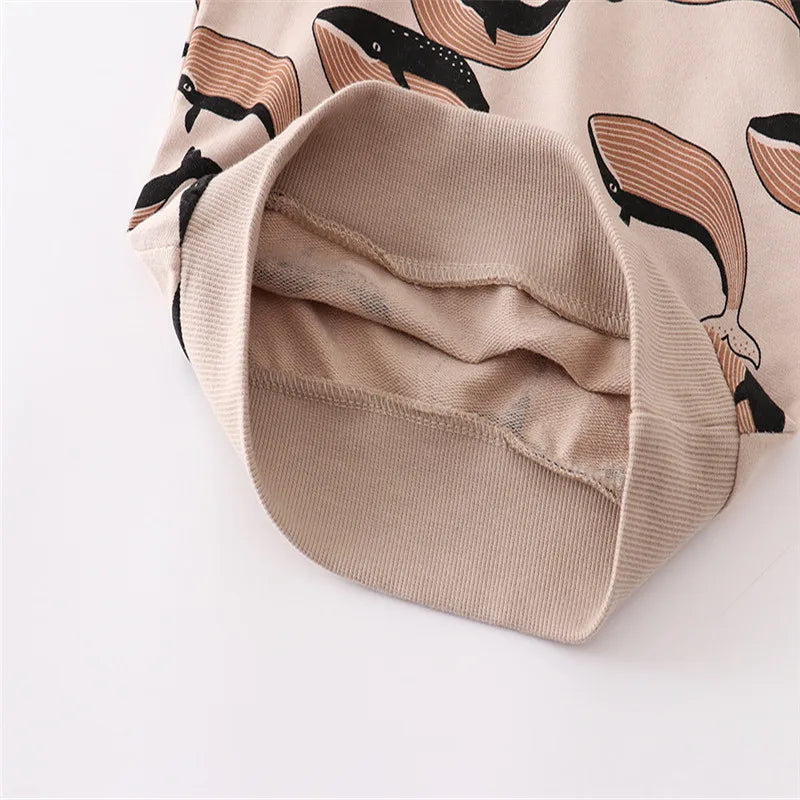 Close-up of the Brown whale-print sweater's ribbed edge and cotton interior
