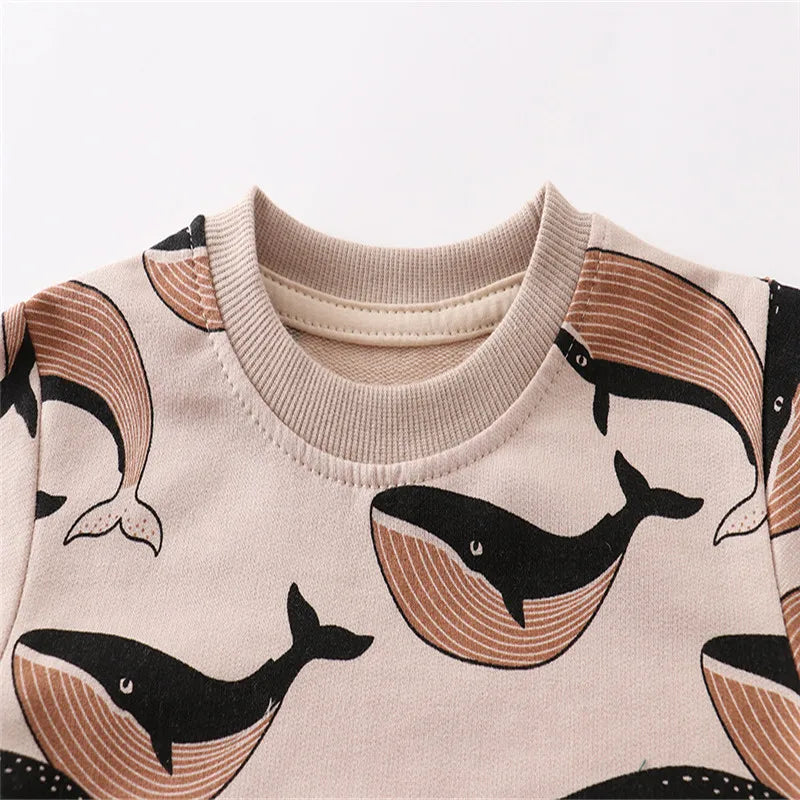 Brown whale-print kids' sweater with a beige ribbed crew neckline