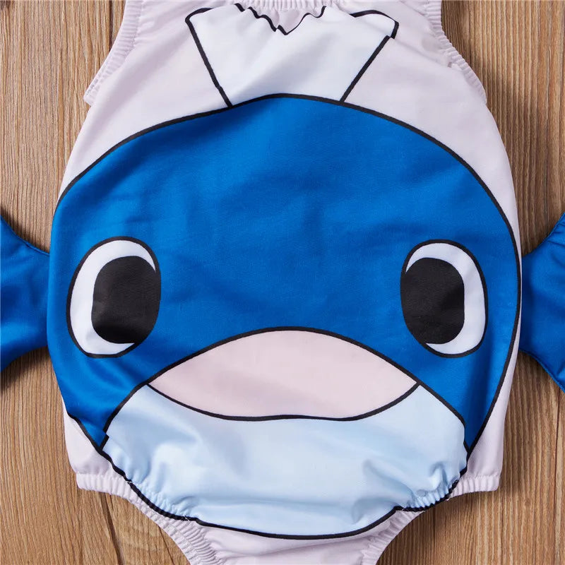 Close-up of the blue whale face and side fins on the pale one-piece swimsuit
