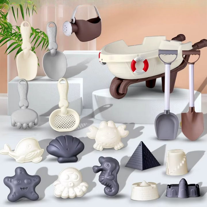 Wheelbarrow and watering can with long shovels, hand tools, and assorted sand molds