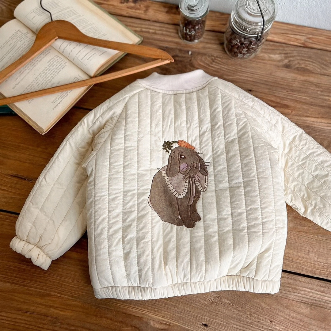 Back of the white quilted jacket with animal embroidery and gathered cuffs