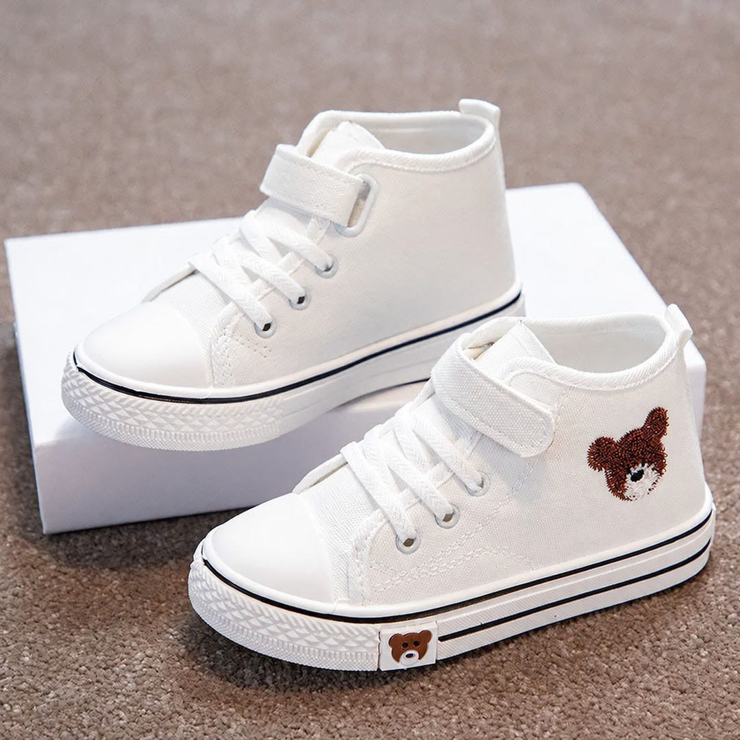 Pair of white canvas high-top sneakers with lace fronts, ankle straps, and bear details