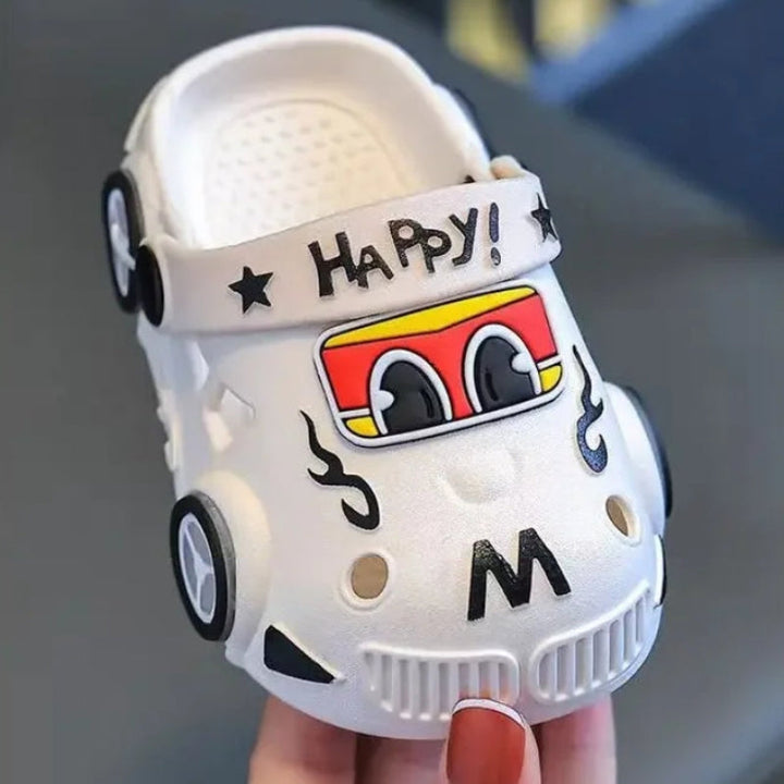 Front view of a white car slipper with cartoon eyes, ventilation holes, and a heel strap.