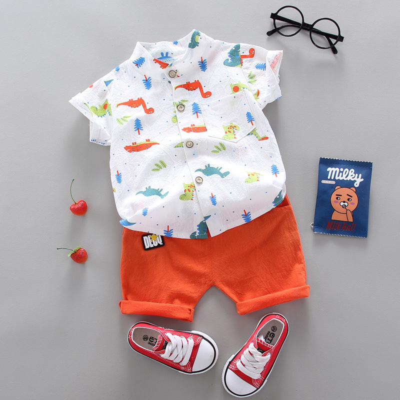 White shirt with colorful dinosaur prints paired with orange cuffed shorts