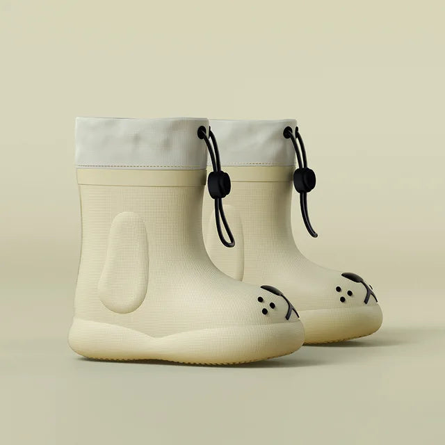 White dog-face rain boots shown as a pair from the side with drawcord cuffs