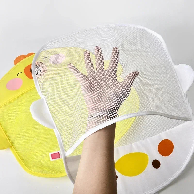 Hand visible through the mesh pocket of a white duck bath toy storage bag