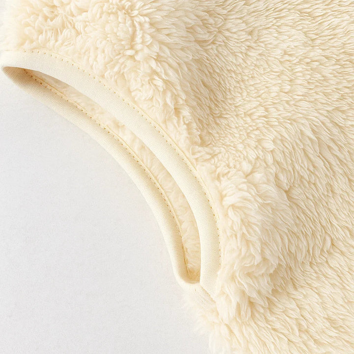 Bound arm opening and plush texture on the white fleece vest