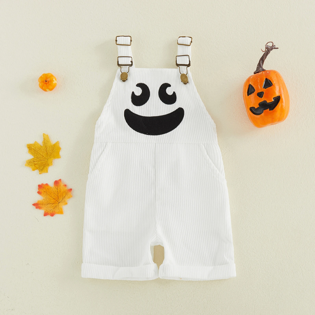 White ribbed ghost overalls with adjustable straps, shown beside fall leaves and a pumpkin decoration.