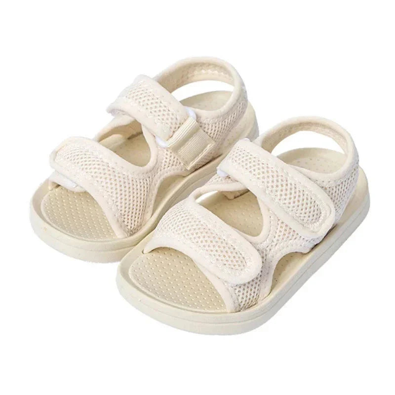 White kids' sandals with two adjustable straps, mesh uppers, and open toes