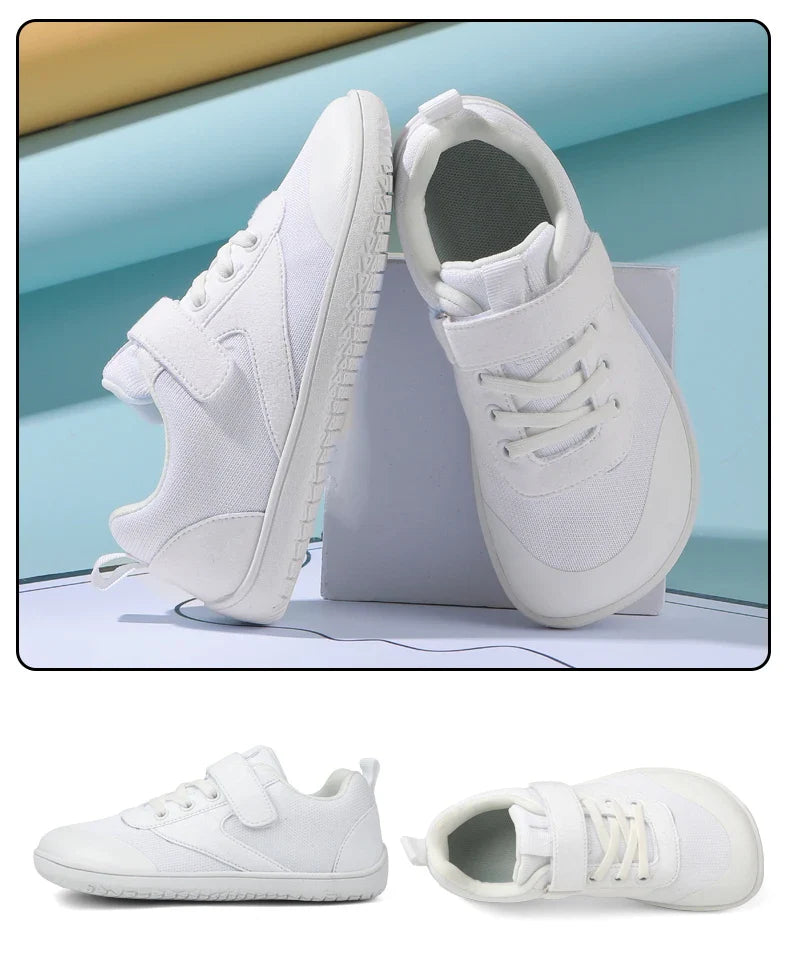 White kids' sneakers shown from the side and above with hook-and-loop straps