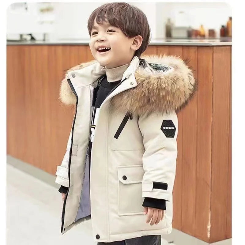 Child wearing a white winter coat open at the front, with fluffy hood trim and flap pockets