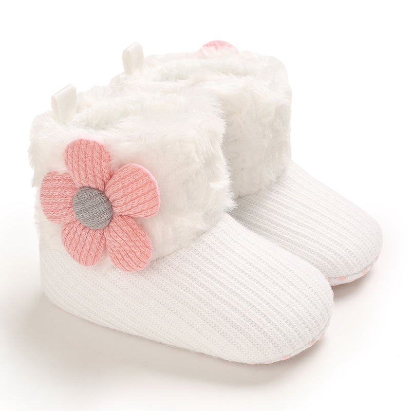 White baby winter boots with pink flower accents and plush cuffs