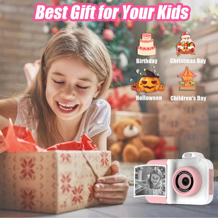 Girl opening a gift beside a white-and-pink camera with a black-and-white print