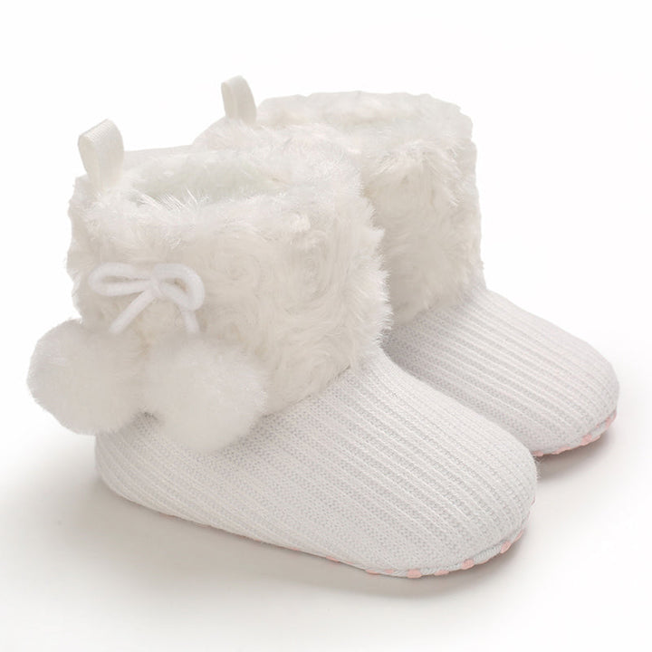 White baby boots with fluffy cuffs and matching pom-pom accents