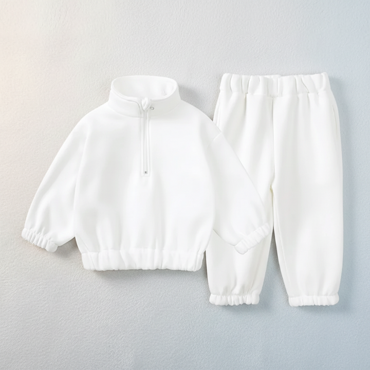 White quarter-zip sweatshirt and matching cuffed jogger pants laid flat