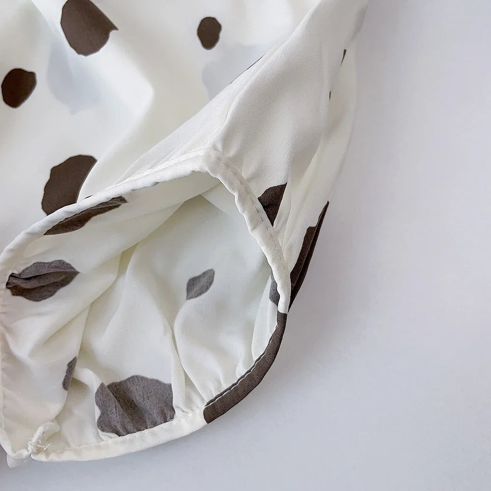 Close-up of the leg opening and fabric edge on the dotted white bottoms