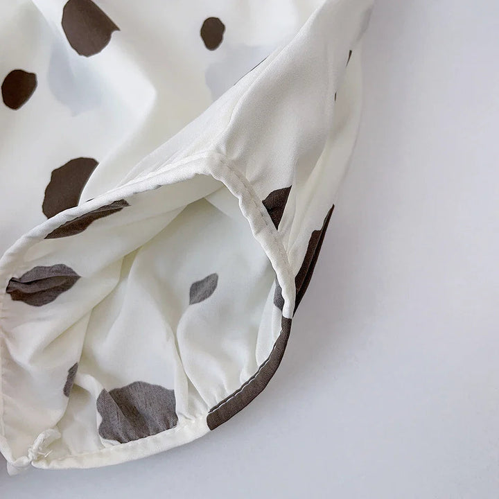 Close-up of the leg opening and fabric edge on the dotted white bottoms