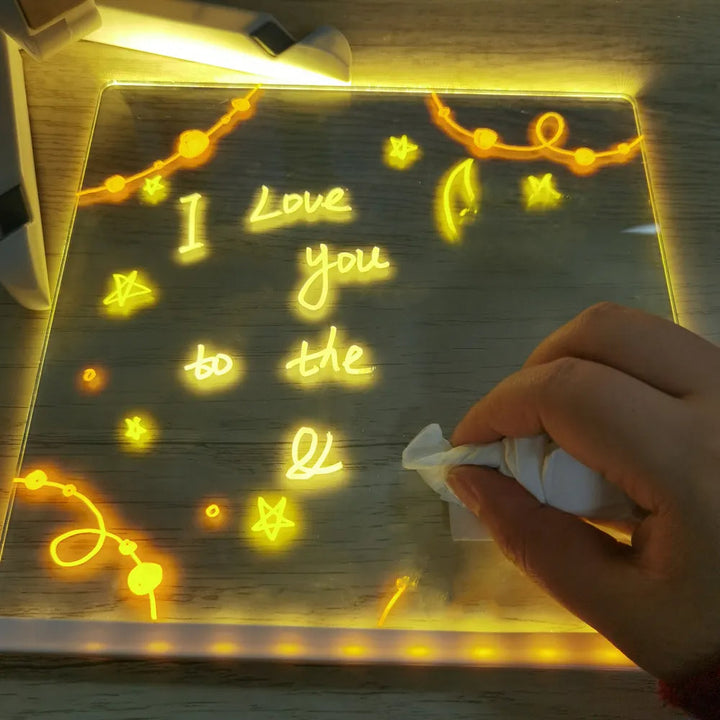 Hand wiping a glowing handwritten message from the drawing board