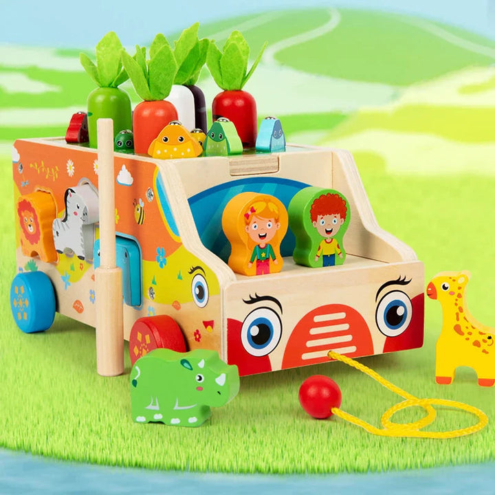 Front view of the wooden activity bus with animal blocks, vegetable pieces, and a pull cord