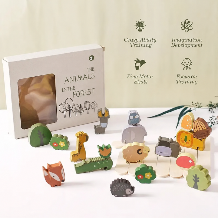Wooden animal stacking set beside its box with blocks and balancing sticks spread out.