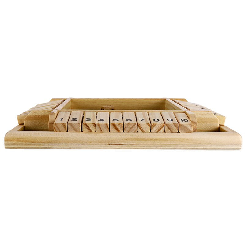 Low side view of the wooden board game with numbered flaps lying flat