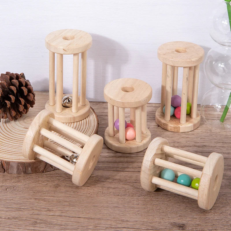 Wooden ball and bell rattles standing upright and lying on their sides on a wooden tabletop