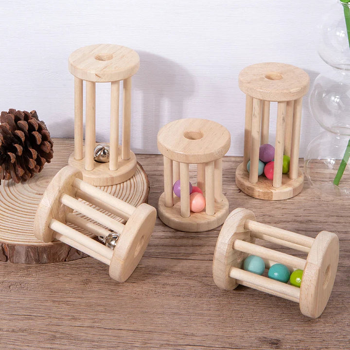 Wooden ball and bell rattles standing upright and lying on their sides on a wooden tabletop