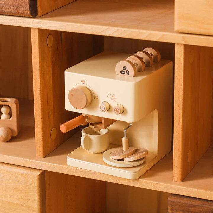 Wooden espresso play set arranged in a cubby with a cup and pretend cookies on a saucer.