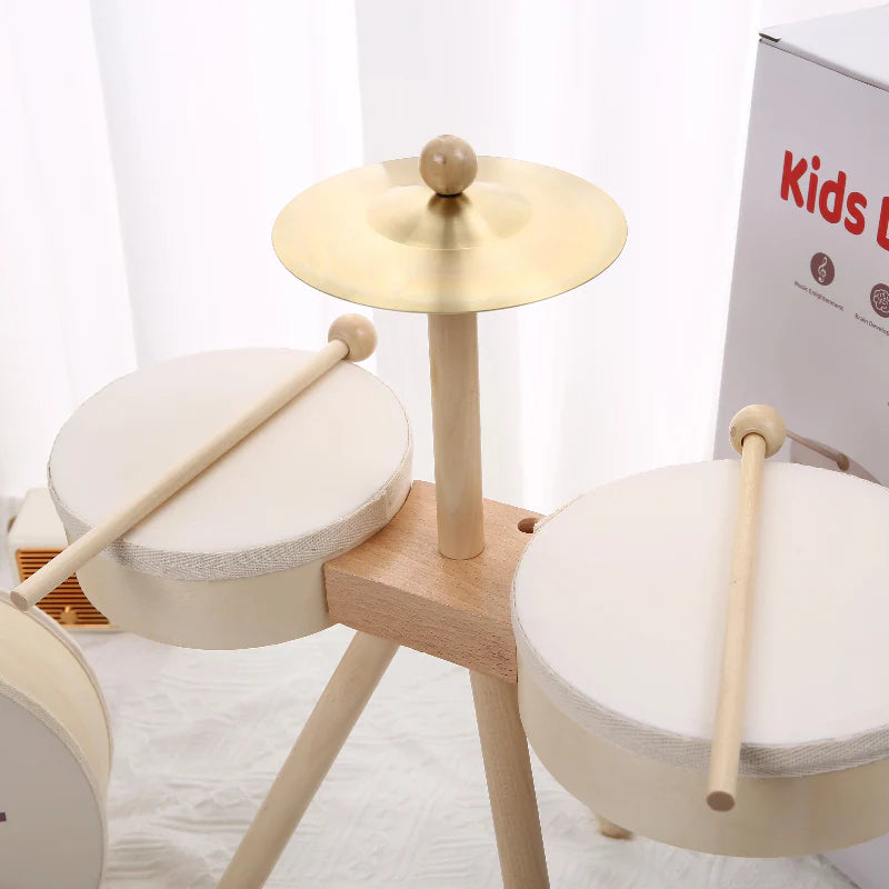 Close-up of two wooden drums, a metal cymbal, and drumsticks on the stand