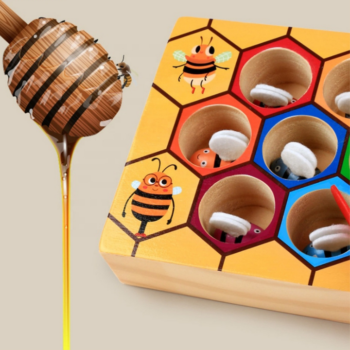 Close-up of bee pieces in the color-bordered openings of the wooden hive board